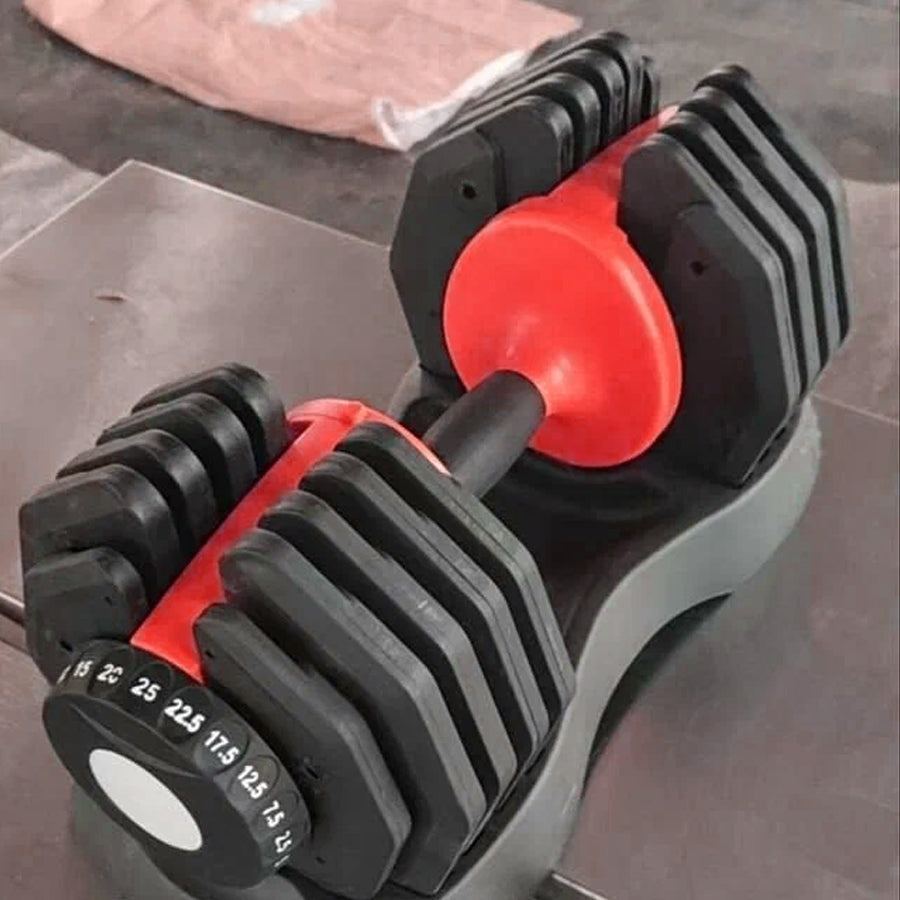 Pair of adjustable dumbbells on a concrete floor