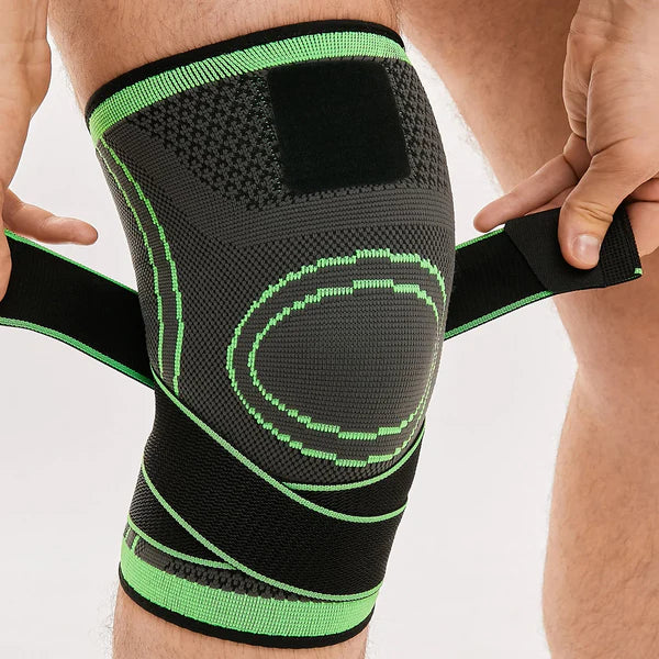 Person wearing a black and green knee brace on a white background