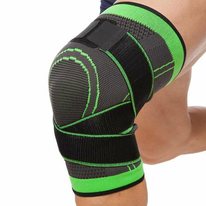 Black and green knee brace on a person's knee against a white background
