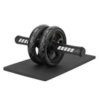 Black ab roller on a black mat with white background