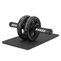 Black ab roller on a black mat with white background