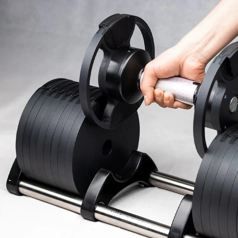 Person attaching weight plates to a barbell on a gray background