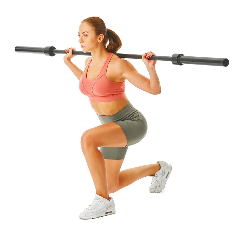 Woman performing a barbell squat on a white background