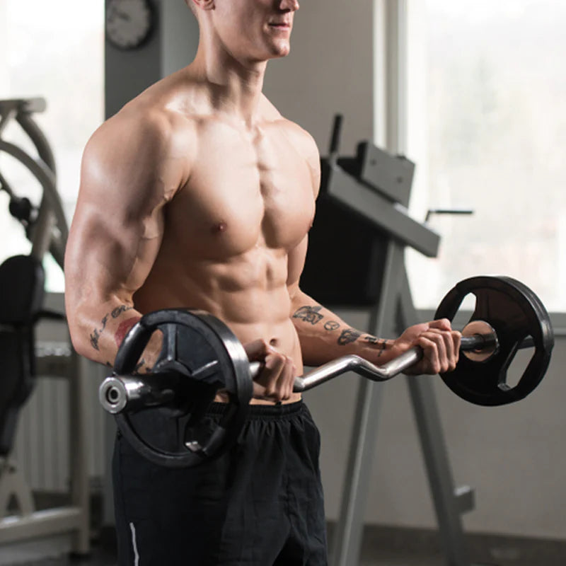Muscular man holding a barbell in a gym setting