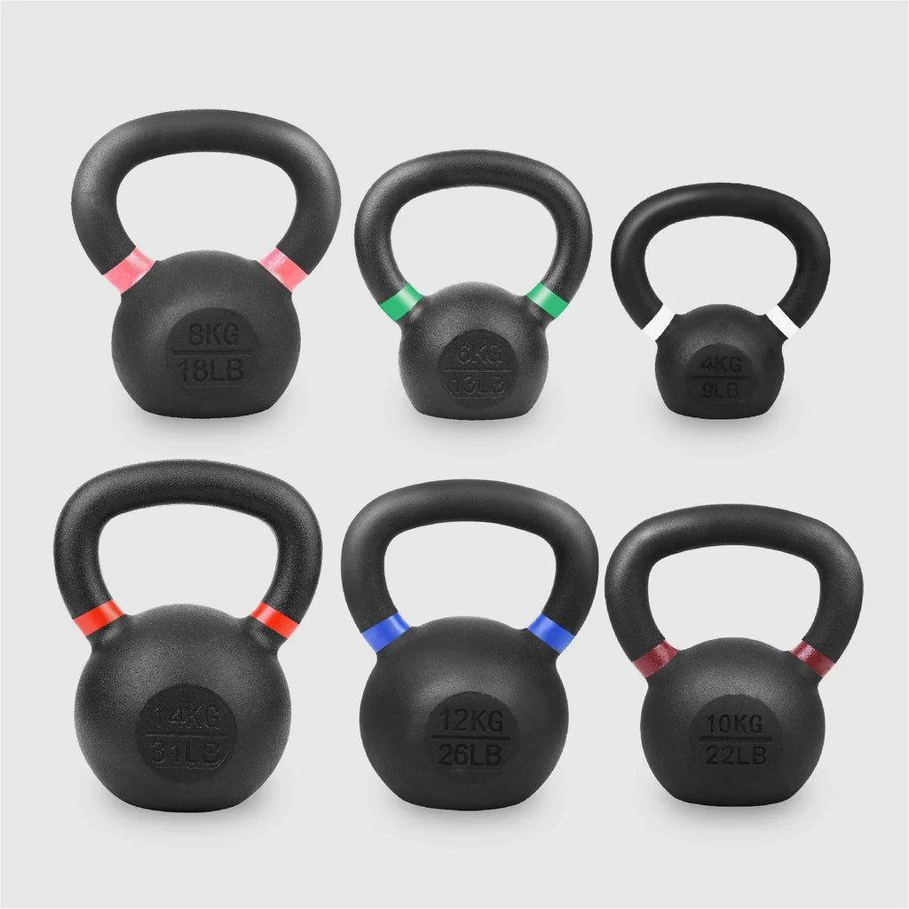Set of six black kettlebells with color-coded weight markings on a light gray background
