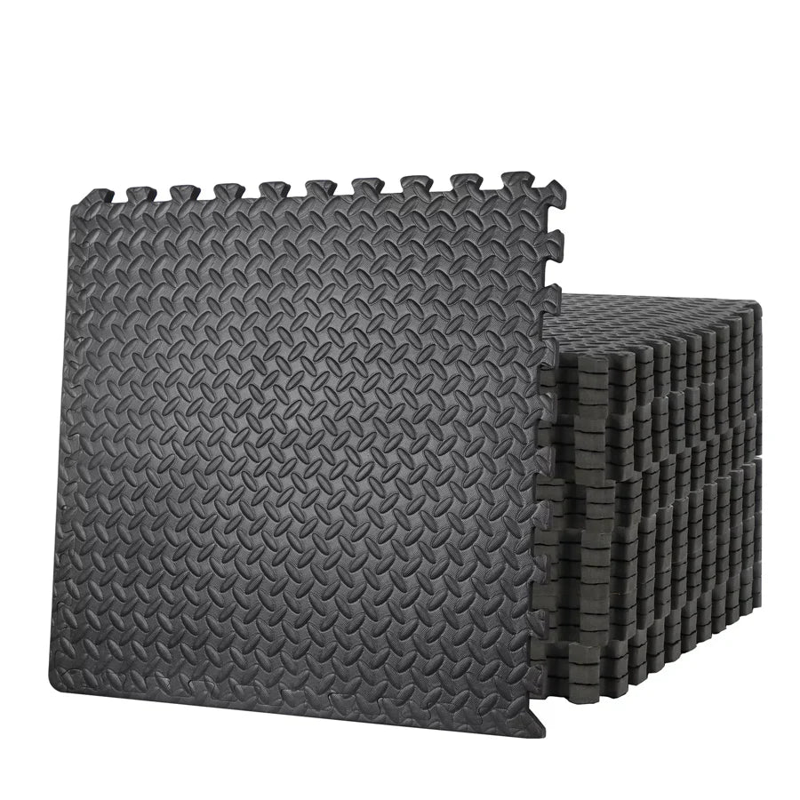 Stack of black interlocking foam mats on a white background