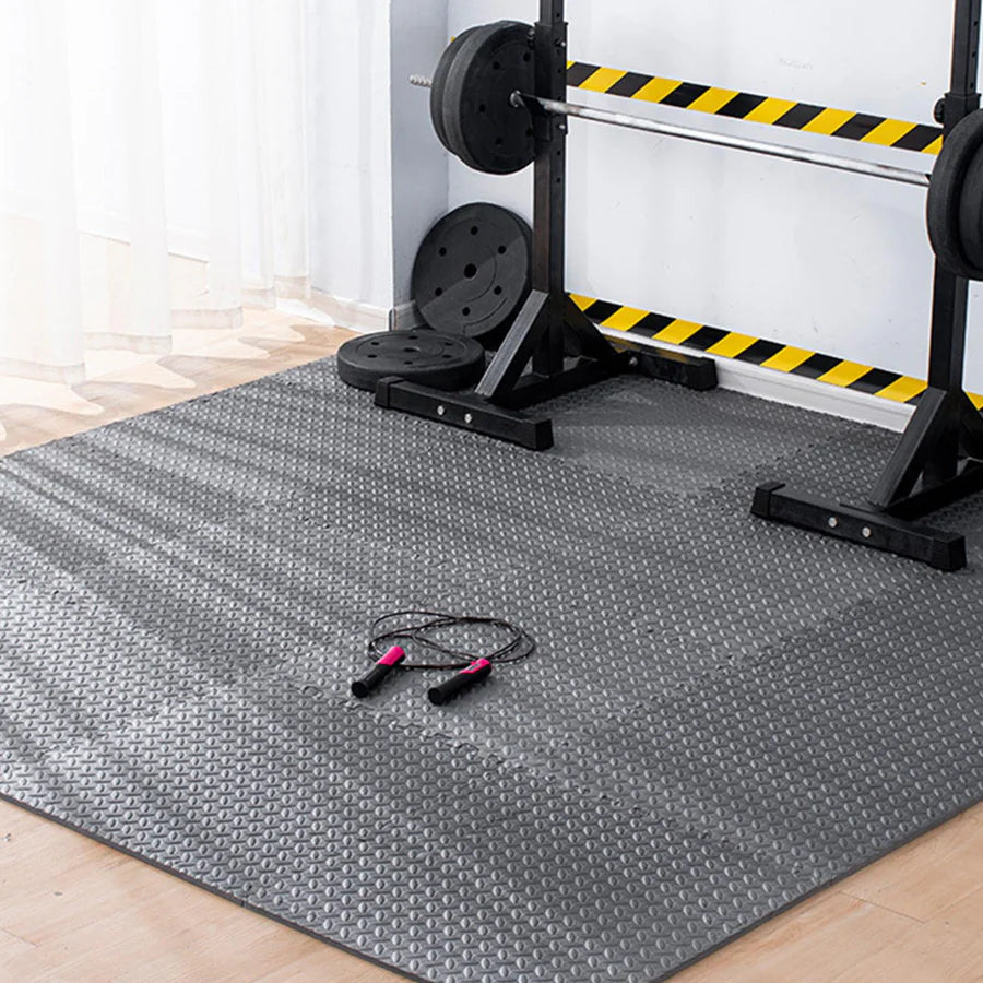 Gym mat with weightlifting equipment in the background