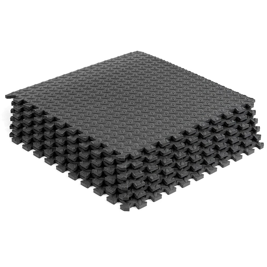 Stack of gray interlocking foam mats on a white background