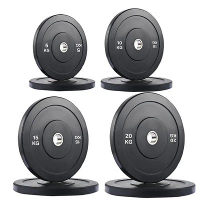 Set of four black weight plates with labeled weights on a white background