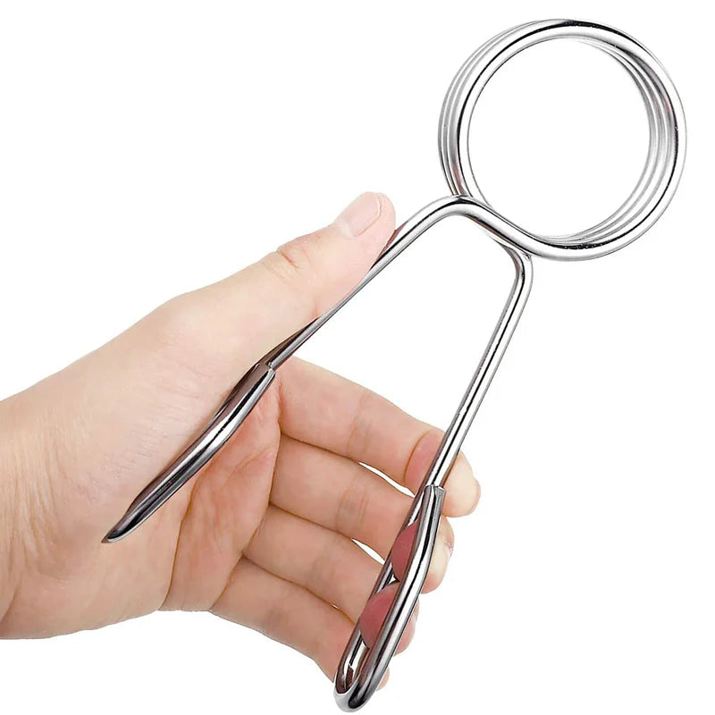 Hand holding a pair of silver scissors against a white background
