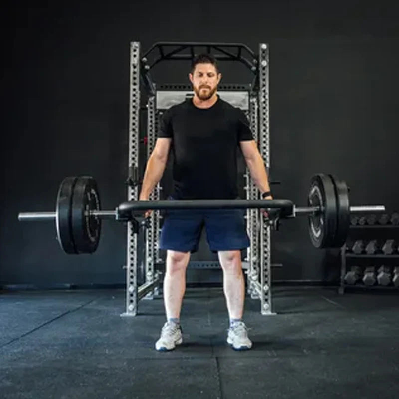 Man lifting a barbell in a gym setting