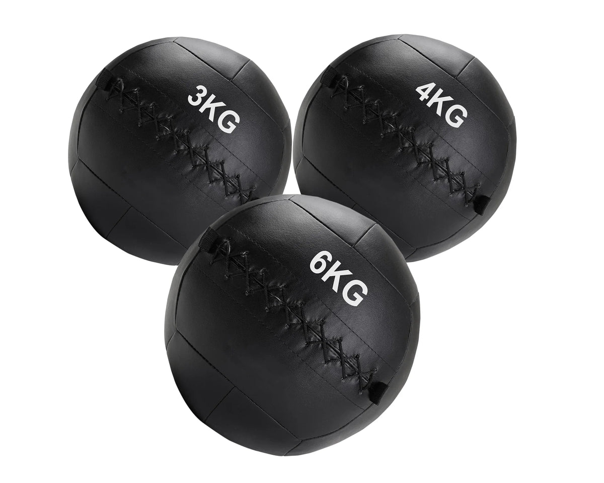 Three black weighted medicine balls with weight markings on a white background