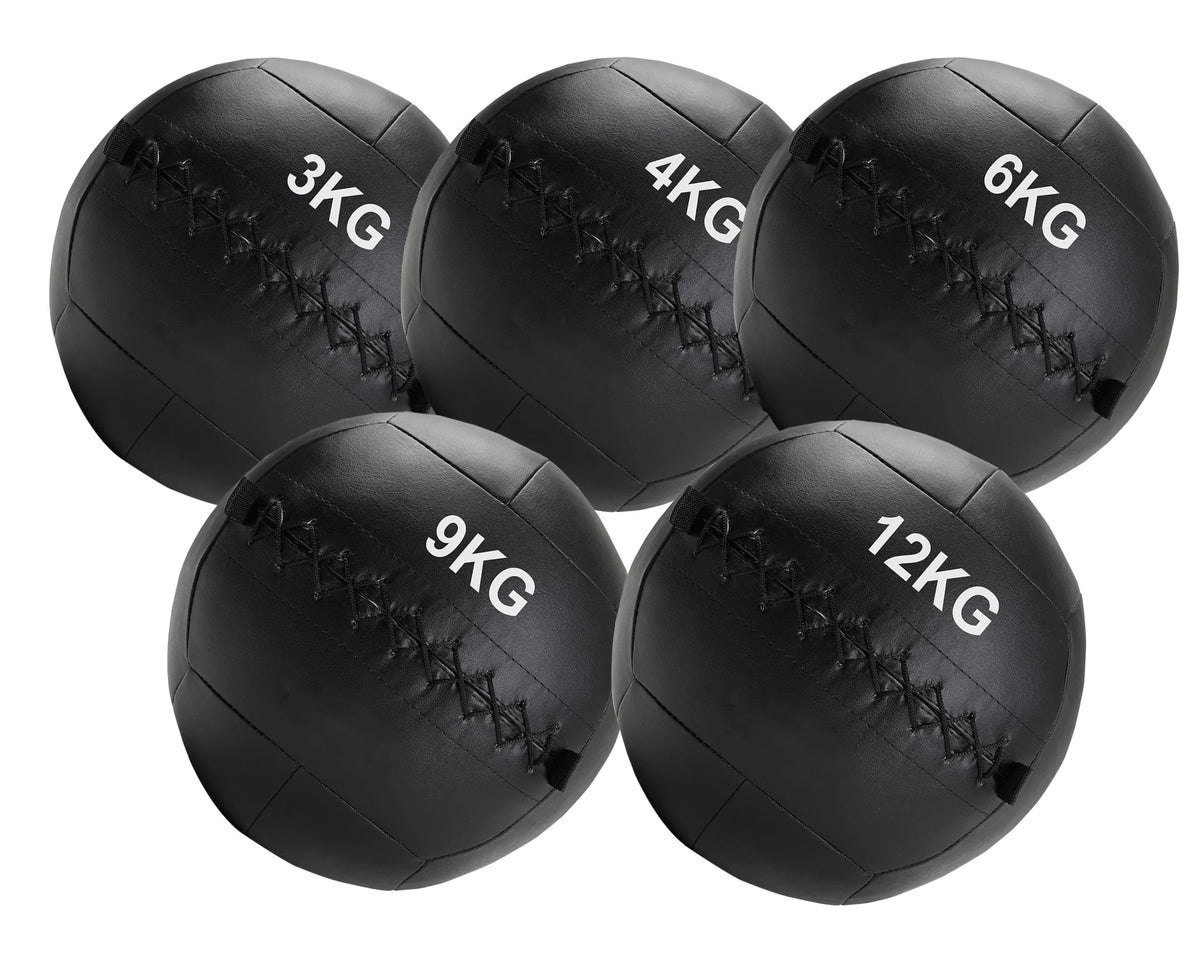 Set of five black weighted medicine balls with labeled weights on a white background