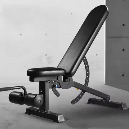 Black adjustable weight bench against a gray concrete wall.