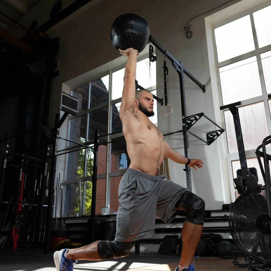 Man exercising with a medicine ball in a gym setting